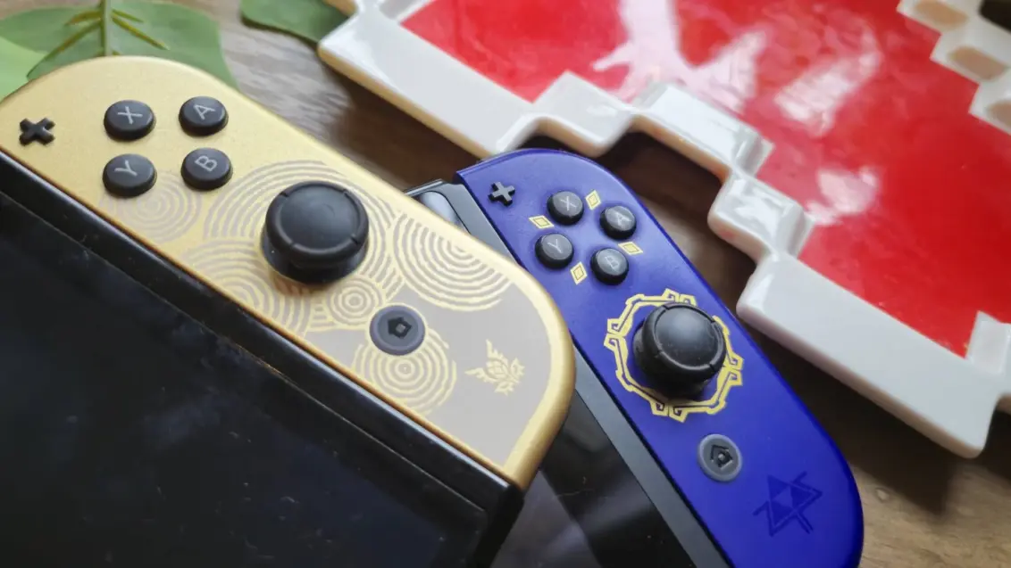 Foto der OLED Tears of the Kingdom Switch, die auf der LCD Switch mit den Skyward Sword HD Joy-Cons liegt.