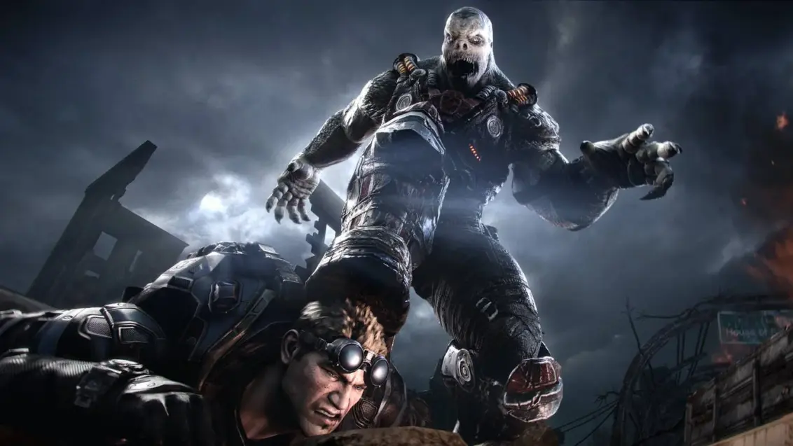 Gears of War Reloaded Bild zeigt eine große, mutierte Kreatur, die einen menschlichen Charakter mit dem Fuß zu Boden drückt